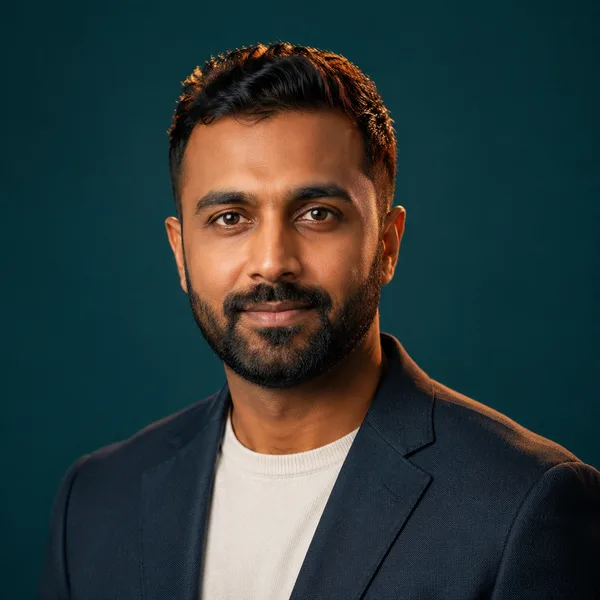 Creative / Modern AI headshot example — professional man in his 30s with a beard (AI-generated, not a real person)